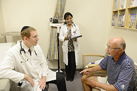 Mark Stein, MD and Chandrika Jeyamohan speak with a patient